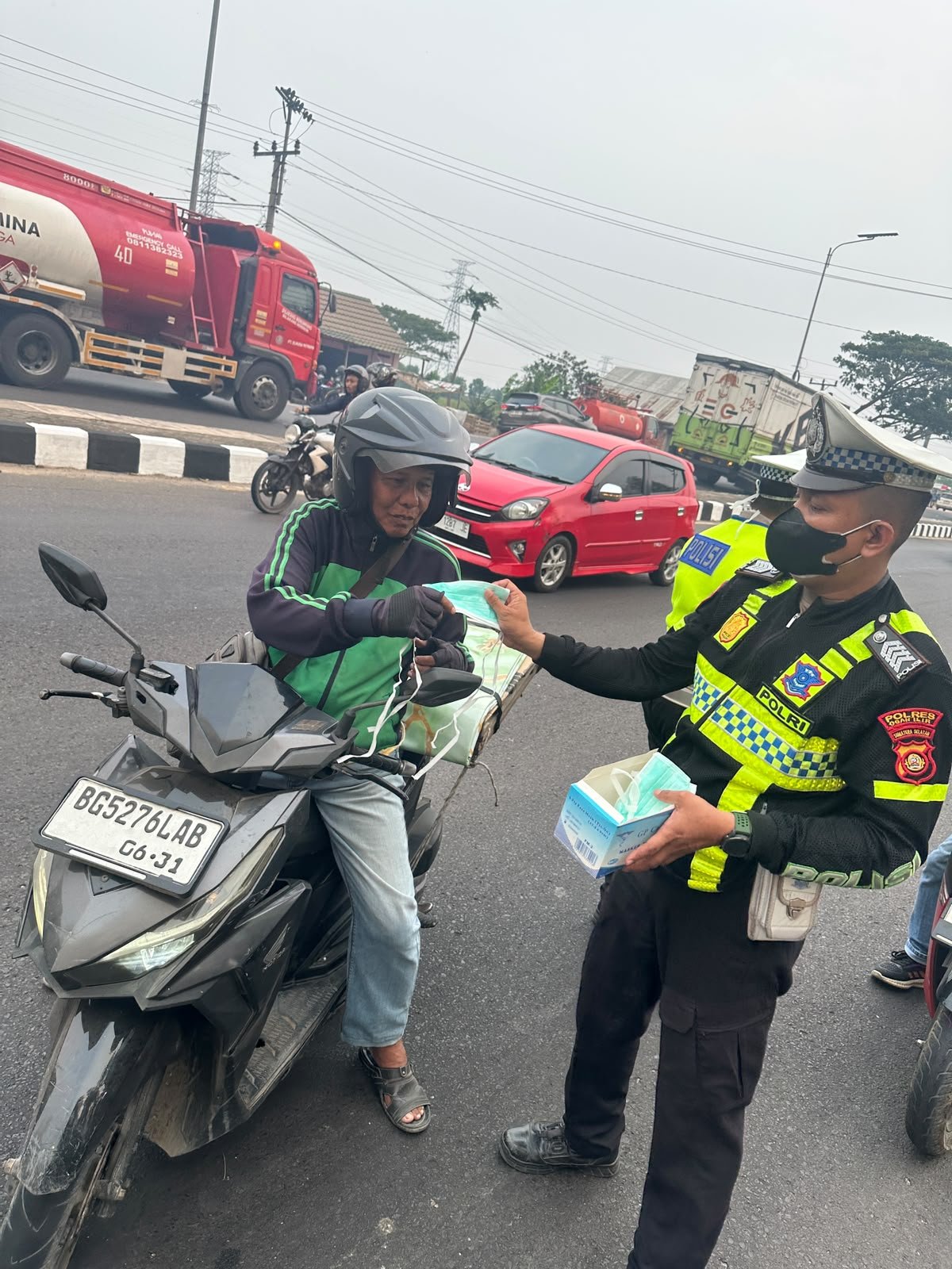 Redam Dampak Asap Karhutla, Sat Lantas Polres Ogan Ilir Gerak Cepat Bagikan Masker dan Atur Lalu Lintas di Lokasi Kebakaran